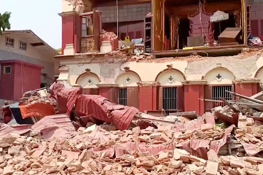 People stand near a collapsed temple following an earthquake in Mandalay, Myanmar, March 28, 2025, in this screengrab taken from social media video. Social Media /via REUTERS  THIS IMAGE HAS BEEN SUPPLIED BY A THIRD PARTY.  NO RESALES. NO ARCHIVES.