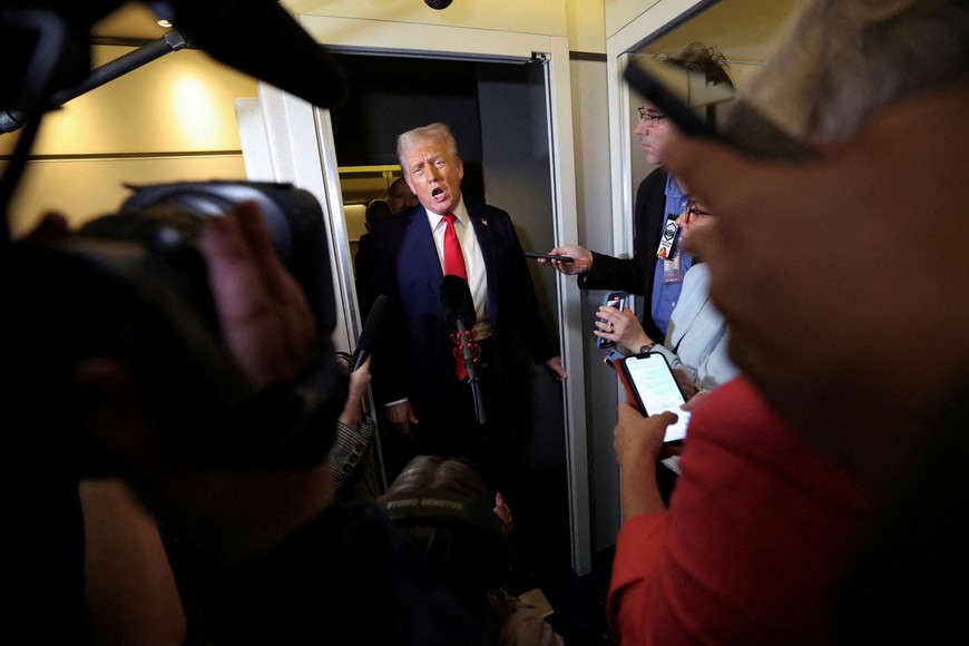 FILE PHOTO: U.S. President Donald Trump speaks to reporters aboard Air Force One on his return to Washington, D.C., U.S., March 30, 2025.  REUTERS/Kevin Lamarque/File Photo