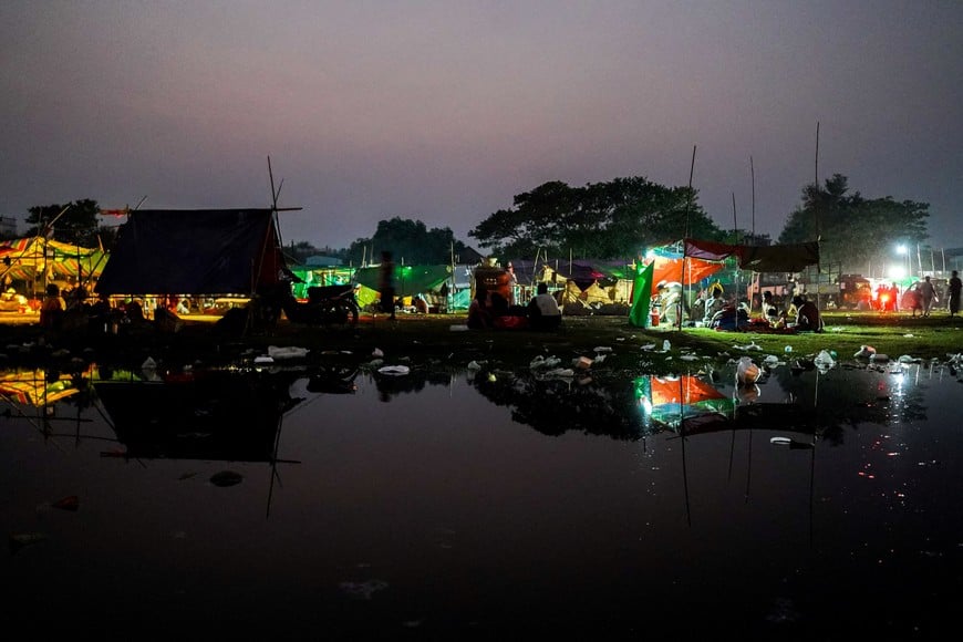 People are seen inside a shelter in a makeshift tent camp following a strong earthquake in Amarapura township, Myanmar, April 3, 2025. REUTERS/Stringer