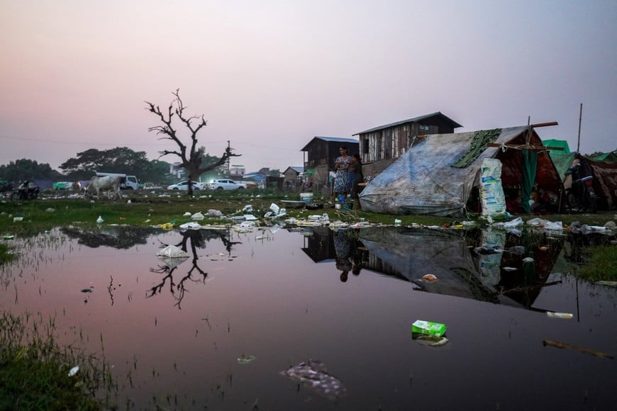 People are seen at a shelter in a makeshift tent camp following a strong earthquake in Amarapura township, Myanmar, April 3, 2025. REUTERS/Stringer
