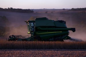 A farm worker operates a combine harvester during the soybean harvest season in Brazil's southernmost state, on a farm in Nao Me Toque, Rio Grande do Sul state, Brazil, April 4, 2025. REUTERS/Diego Vara