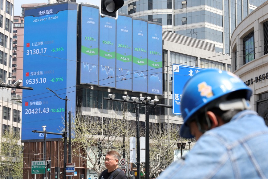 An electronic board shows Shanghai, Shenzhen, and Hang Seng stock indices in Shanghai, China April 7, 2025.  REUTERS/Go Nakamura