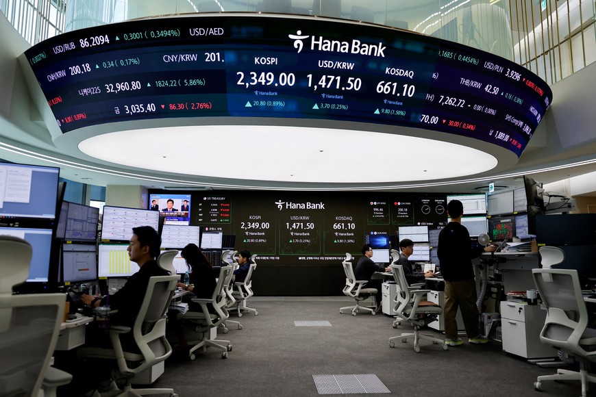 Currency dealers work as electronic boards show the Korea Composite Stock Price Index (KOSPI) and the exchange rate between the U.S. dollar and South Korean won, at the dealing room of a bank, in Seoul, South Korea, April 8, 2025. REUTERS/Kim Soo-hyeon