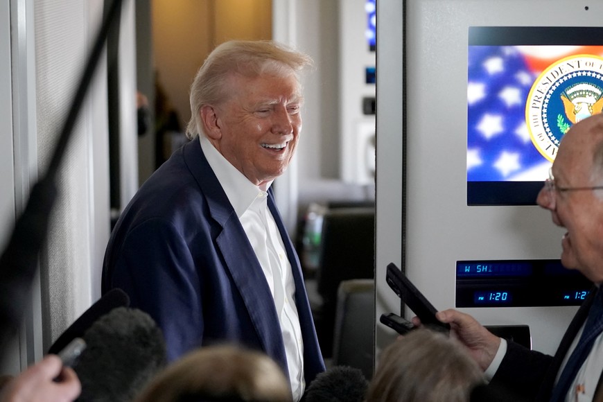 U.S President Donald Trump speaks to members of press onboard Air Force One on a flight to Fiumicino Airport near Rome to attend the funeral of Pope Francis, April 25, 2025. REUTERS/Nathan Howard
