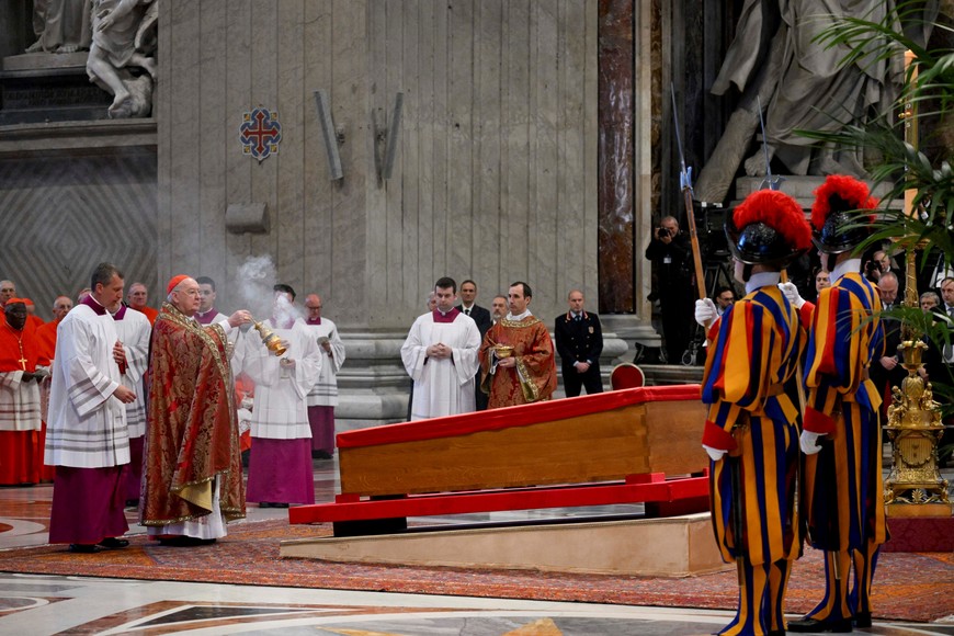 Cardinal Camerlengo Kevin Joseph Farrell swings a thurible of incense as Pope Francis's body rests inside his coffin, on the day of the translation of his body, in St. Peter's Basilica at the Vatican, April 23, 2025.    Vatican Media/­Handout via REUTERS    ATTENTION EDITORS - THIS IMAGE WAS PROVIDED BY A THIRD PARTY.