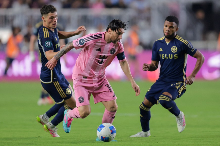 Apr 30, 2025; Ft. Lauderdale, Florida, USA; Inter Miami CF forward Lionel Messi (10) dribbles the ball past Vancouver Whitecaps midfielder Sebastian Berhalter (16) during the second half at Chase Stadium. Mandatory Credit: Sam Navarro-Imagn Images
