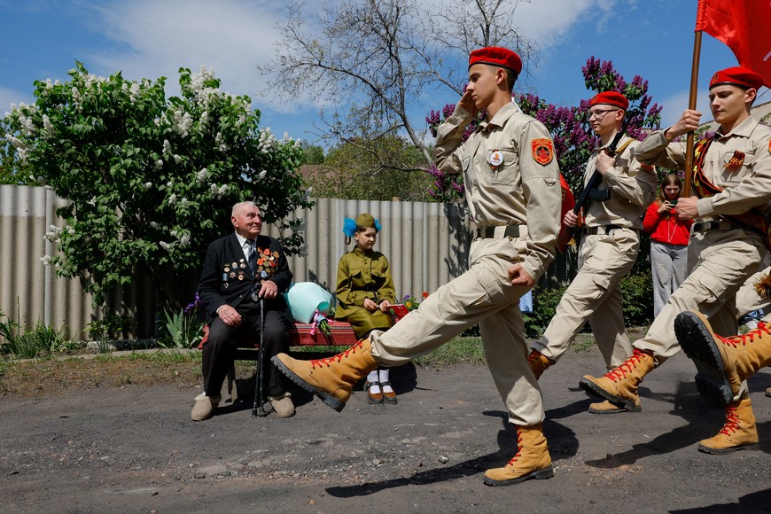World War Two veteran Vasily Pampukhov, aged 102, who was drafted into the Red Army in 1943, served in the air defence and ended up fighting in Prague, watches a parade as he receives congratulations on the upcoming Victory Day marking the 80th anniversary of the victory over Nazi Germany, in the course of Russia-Ukraine conflict in Pelahiivka (Pelageyevka) in the Donetsk region, a Russian-controlled area of Ukraine, May 7, 2025. REUTERS/Alexander Ermochenko