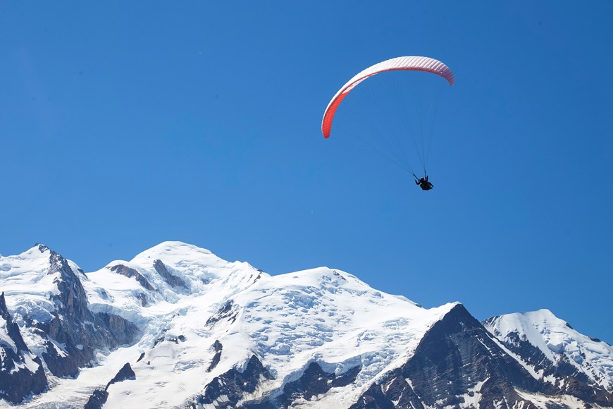A paraglider flies over the Mont-Blanc mountain from Le Brevent in Chamonix, France, July 20, 2020. REUTERS/Denis Balibouse