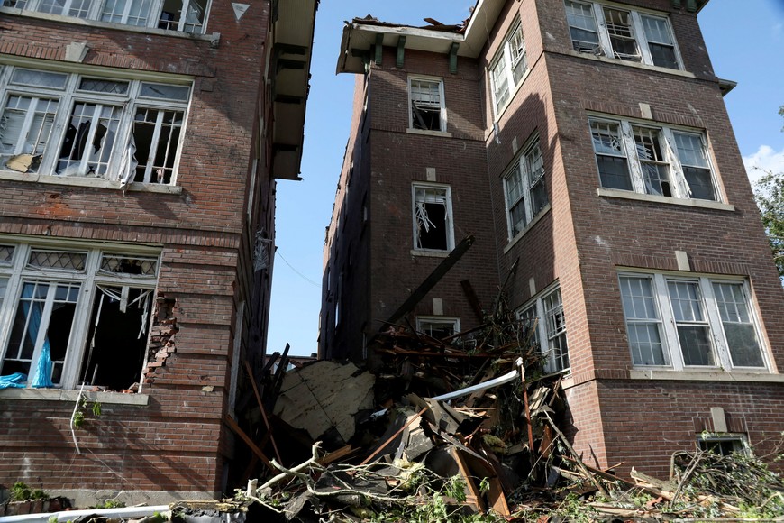 Debris fills the alley between two heavily damaged apartment buildings after tornadoes ripped through shattering windows and tearing through brick walls in St. Louis, Missouri,U.S. May 16, 2025 REUTERS/Lawrence Bryant