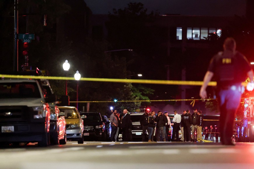 Emergency personnel work at the site where, according to the U.S. Homeland Security Secretary, two Israeli embassy staff were shot dead near the Capital Jewish Museum in Washington, D.C., U.S. May 22, 2025.  REUTERS/Jonathan Ernst