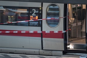 Cordon tape is attached to a train at Hamburg's main train station, after several people were injured in a knife attack, in Hamburg, Germany, May 23, 2025. REUTERS/Fabian Bimmer