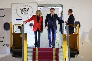 France's President Emmanuel Macron and his wife Brigitte Macron arrive at Noi Bai International Airport, marking the first trip to Vietnam by a French president in nearly a decade, in Hanoi, Vietnam, May 25, 2025. REUTERS/Chalinee Thirasupa