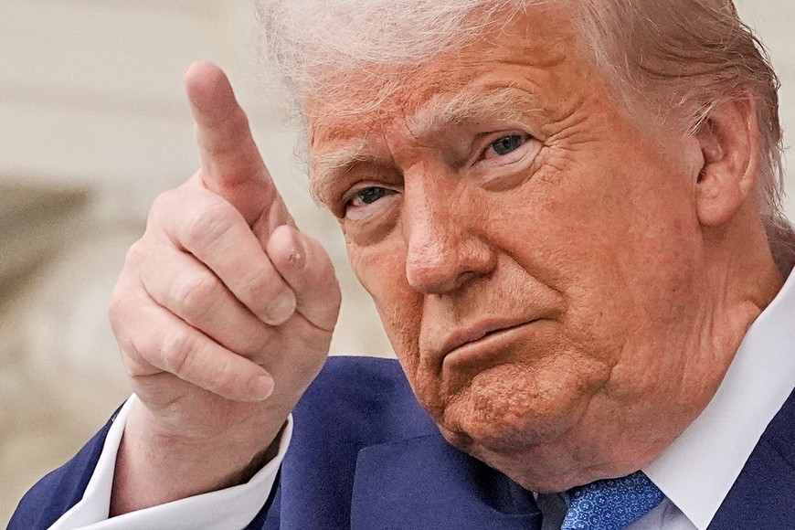 U.S. President Donald Trump gestures at the annual National Memorial Day Observance in the Memorial Amphitheater, at Arlington National Cemetery in Arlington, Virginia, U.S., May 26, 2025. REUTERS/Ken Cedeno     TPX IMAGES OF THE DAY