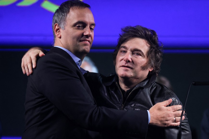Argentina's President Javier Milei and presidential spokesperson Manuel Adorni embrace during a rally in Buenos Aires, Argentina, May 14, 2025. REUTERS/Tomas Cuesta