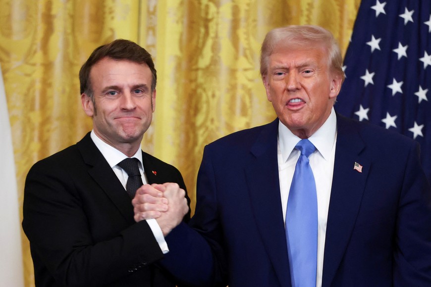 U.S. President Donald Trump and French President Emmanuel Macron pose for pictures on the day of a press conference, at the White House in Washington, D.C., U.S., February 24, 2025. REUTERS/Evelyn Hockstein     TPX IMAGES OF THE DAY