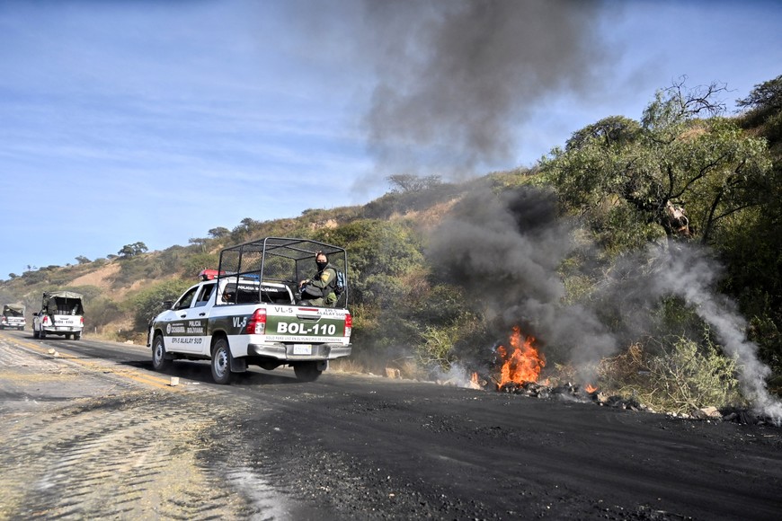 Police officers ride a vehicle as they remove a highway blockade set by supporters of former Bolivian President Evo Morales, in Parotani, Bolivia June 11, 2025. REUTERS/Claudia Morales