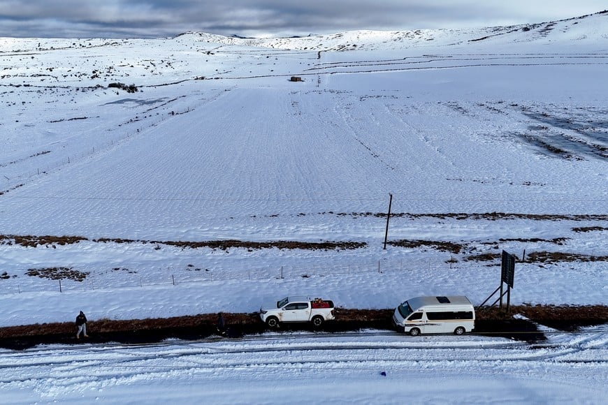 Cars are surrounded by snow during a severe cold front in Barkly East, Eastern Cape Province, South Africa, June 11, 2025. REUTERS/Thando Hlophe