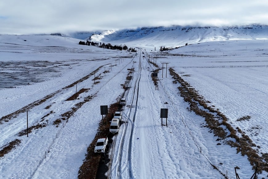 Cars are surrounded by snow during a severe cold front in Barkly East, Eastern Cape Province, South Africa, June 11, 2025. REUTERS/Thando Hlophe