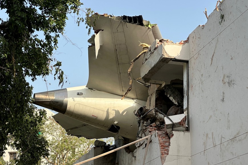 A tail of an Air India Boeing 787 Dreamliner plane that crashed is seen stuck on a building after the incident in Ahmedabad, India, June 12, 2025. REUTERS/Amit Dave     TPX IMAGES OF THE DAY
