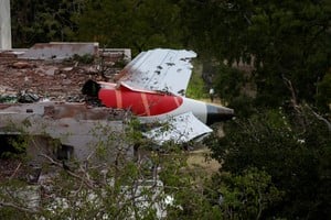 A tail of an Air India Boeing 787 Dreamliner plane that crashed is seen stuck on a building after the incident in Ahmedabad, India, June 12, 2025. REUTERS/Amit Dave