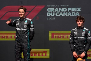 Formula One F1 - Canadian Grand Prix - Circuit Gilles Villeneuve, Montreal, Quebec, Canada - June 15, 2025
Mercedes' George Russell celebrates on the podium after winning the Canadian Grand Prix with third placed Mercedes' Andrea Kimi Antonelli REUTERS/Mathieu Belanger