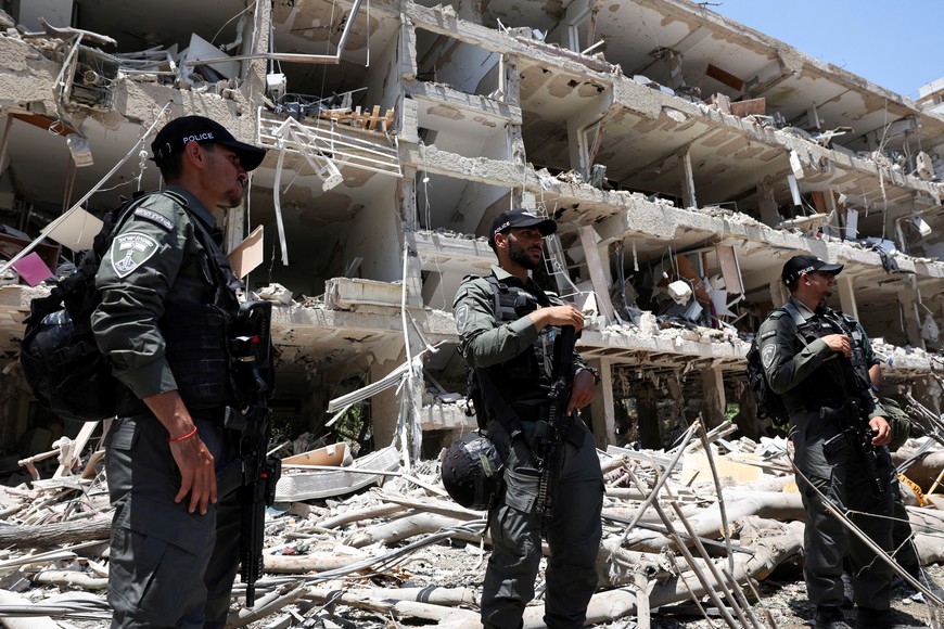 FILE PHOTO: Police officers stand guard at an impact site following a missile attack from Iran on Israel, amid the Iran-Israel conflict, in Tel Aviv, Israel, June 22, 2025. REUTERS/Violeta Santos Moura/File Photo