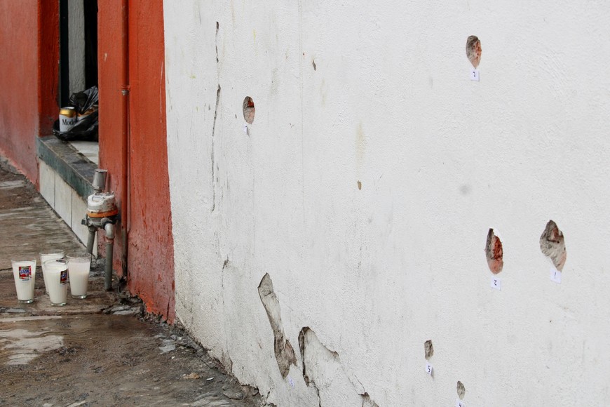 Votive candles are placed near the bullet-riddled house where gunmen opened fire on Tuesday during a party celebrating the Nativity of John the Baptist, leaving several casualties, in Irapuato, Guanajuato state, Mexico June 25, 2025. REUTERS/Juan Moreno