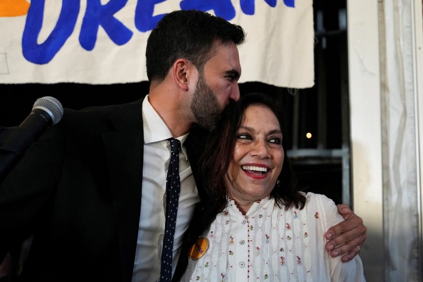 Zohran Mamdani kisses his mother Mira Nair during a watch party for his primary election, which includes his bid to become the Democratic candidate for New York City mayor in the upcoming November 2025 election, in New York City, U.S., June 25, 2025. REUTERS/David 'Dee' Delgado