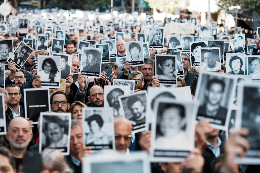 FILE PHOTO: People hold images of the victims of the 1994 bombing attack on the Argentine Israeli Mutual Association (AMIA) community centre, marking the 30th anniversary of the attack, in Buenos Aires, Argentina July 18, 2024. REUTERS/Irina Dambrauskas/File Photo