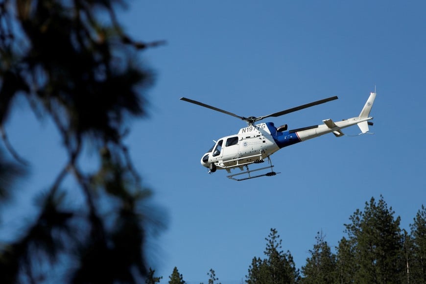 A United States Customs and Border Protection helicopter lifts off from Cherry Hill Park after multiple firefighters were attacked when responding to a fire in the Canfield Mountain area outside Coeur d’Alene, Idaho, U.S. June 29, 2025.  REUTERS/Young Kwak