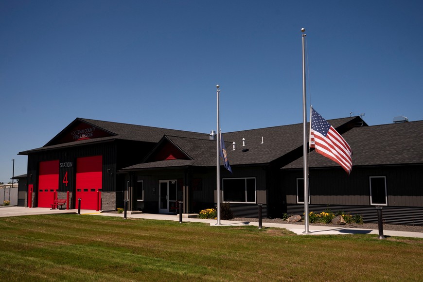 Flags fly at half-staff at the Kootenai County Fire and Rescue Station 4 a day after two firefighters were shot dead while responding to a fire and the body of a man was later found with a gun nearby in the Canfield Mountain area outside Coeur d'Alene, Idaho, U.S. June 30, 2025.  REUTERS/David Ryder