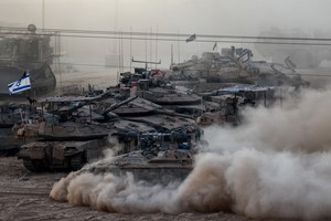 An Israeli APC manoeuvres next to other military vehicles on the Israeli side of the Israel-Gaza border, July 16, 2025. REUTERS/Amir Cohen