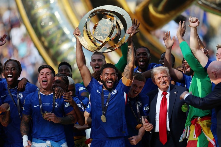 Soccer Football - FIFA Club World Cup - Final - Chelsea v Paris St Germain - MetLife Stadium, East Rutherford, New Jersey, U.S. - July 13, 2025
Chelsea's Reece James lifts the trophy as he celebrates with teammates after winning the FIFA Club World Cup as President Donald Trump reacts REUTERS/Hannah Mckay
