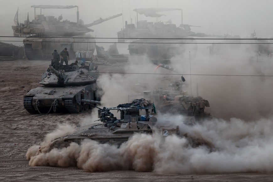 An Israeli APC manoeuvres next to other military vehicles on the Israeli side of the Israel-Gaza border, July 16, 2025. REUTERS/Amir Cohen