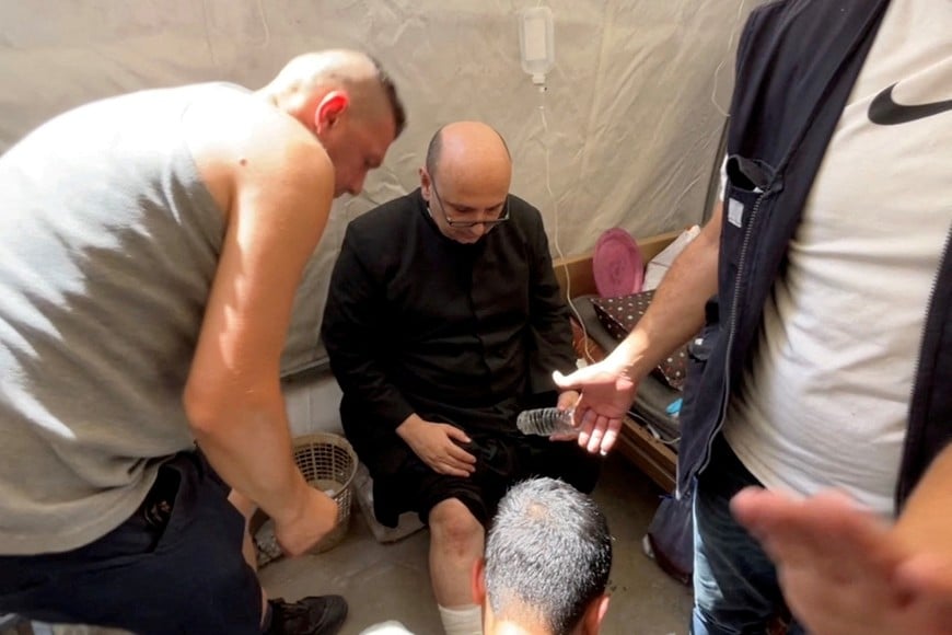Parish priest of the Church of the Holy Family,  father Gabriele Romanelli, receives medical attention, after he suffered light leg injuries following an Israeli strike on the church, according to medics, at Al-Ahli Arab Hospital in Gaza City, in this still image taken from a video July 17, 2025. REUTERS/Dawoud Abu Alkas     TPX IMAGES OF THE DAY