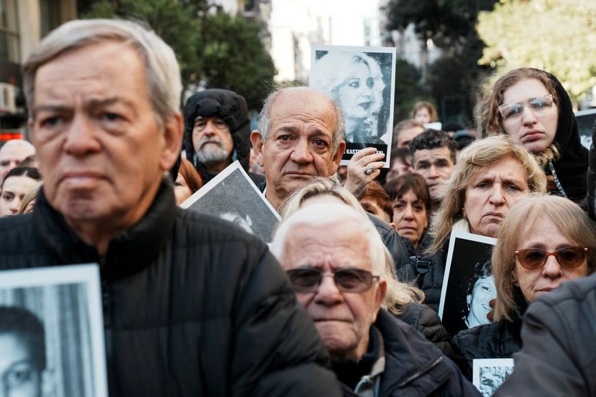 People hold images of the victims of the 1994 bombing attack on the Argentine Israeli Mutual Association (AMIA) community centre, marking the 30th anniversary of the attack, in Buenos Aires, Argentina July 18, 2024. REUTERS/Irina Dambrauskas
