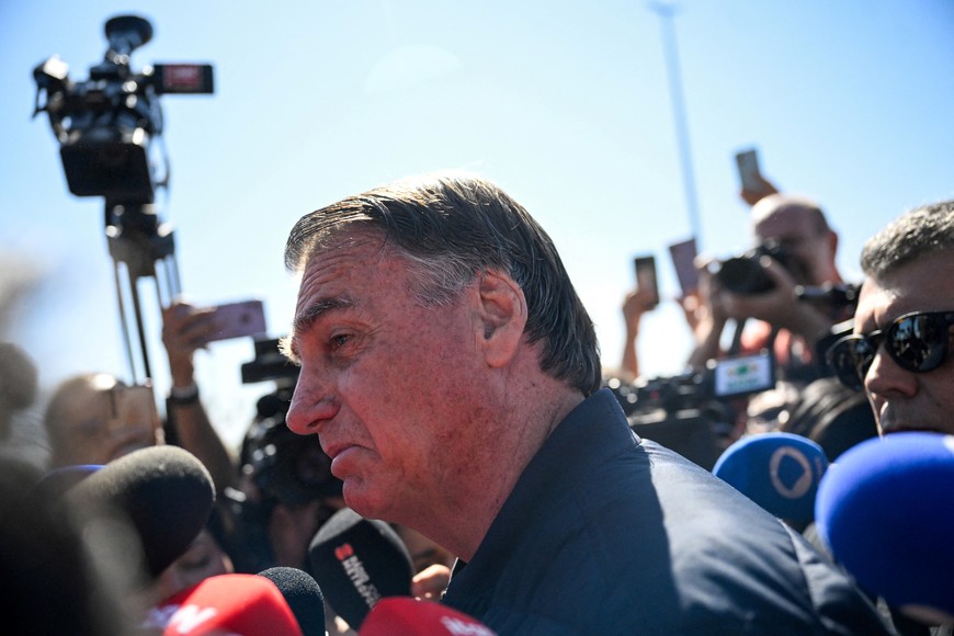 Brazil's former President Jair Bolsonaro speaks to media as he leaves the State Secretariat of Penitentiary Administration headquarters in Brasilia, Brazil July 18, 2025. REUTERS/Mateus Bonomi
