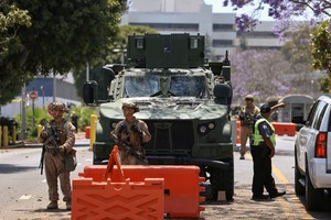 FILE PHOTO: U.S. Marines stand watch at a checkpoint as they guard a federal building, in Los Angeles, California, U.S. June 20, 2025. REUTERS/David Swanson/File Photo