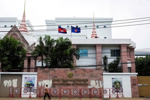 A woman walks past the Royal Embassy of Cambodia, after Thailand recalled its ambassador to Cambodia and said it would expel Cambodia's ambassador, following a landmine incident that injured Thai soldiers and recent clashes along the disputed border between the two countries, in Bangkok, Thailand, July 24, 2025. REUTERS/Chalinee Thirasupa