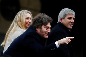 Argentina's President Javier Milei gestures next to Argentine Economy Minister Luis Caputo and General Secretary of the Presidency of Argentina Karina Milei during the official opening ceremony of the Rural Society's 137th annual exhibition, in Buenos Aires, Argentina, July 26, 2025. REUTERS/Matias Baglietto