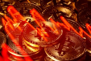 FILE PHOTO: Illumination of the stock graph is seen on the representations of virtual currency Bitcoin in this picture illustration taken taken March 13, 2020. REUTERS/Dado Ruvic/Illustration/File Photo