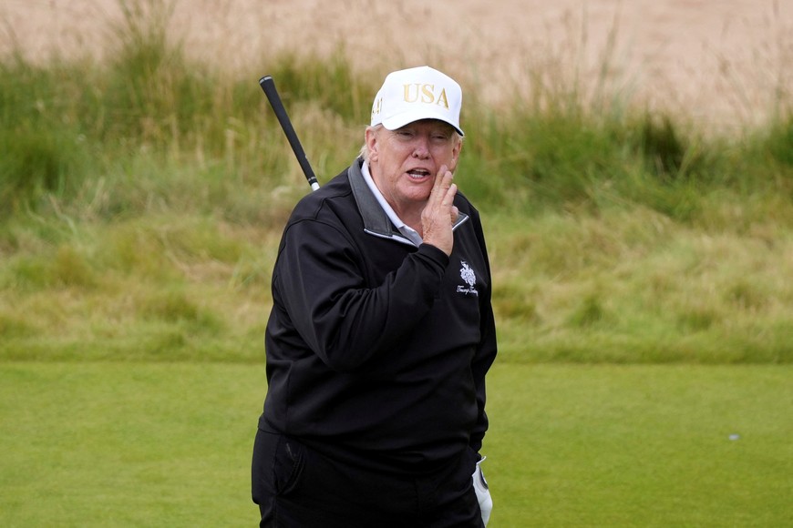 U.S. President Donald Trump gestures as he starts playing golf after the opening ceremony for Trump International Golf Links near Aberdeen, Scotland, Britain July 29, 2025.  Alastair Grant/Pool via REUTERS