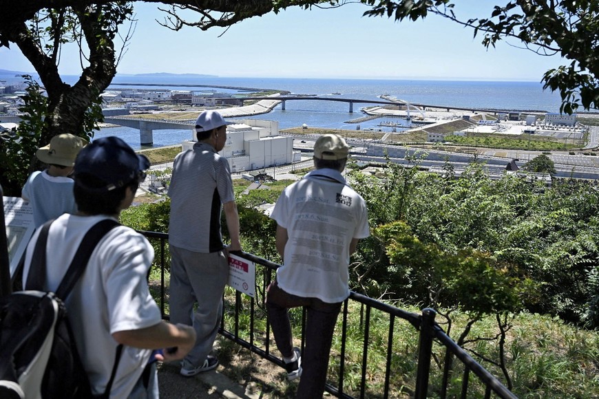 People watch the coastal area from Hiyoriyama Park after Japan issued evacuation alert following major quake in Russia's Kamchatka Peninsula that triggered a tsunami warning, in Ishinomaki, Miyagi prefecture, Japan July 30, 2025, in this photo taken by Kyodo. Kyodo/via REUTERS ATTENTION EDITORS - THIS IMAGE HAS BEEN SUPPLIED BY A THIRD PARTY. MANDATORY CREDIT. JAPAN OUT. NO COMMERCIAL OR EDITORIAL SALES IN JAPAN. BEST QUALITY AVAILABLE.     TPX IMAGES OF THE DAY
