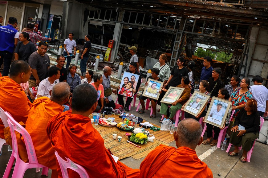 Relatives of people who lost their lives when a Cambodian artillery shell slammed into a gas station and destroyed the attached 7-Eleven convenience store, attend a religious ceremony in Sisaket province, Thailand, July 30, 2025. REUTERS/Athit Perawongmetha