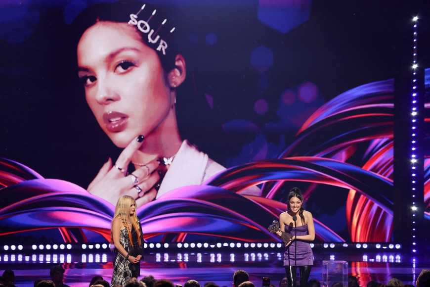 Olivia Rodrigo receives the Female Artist of the Year award as she stands next to Avril Lavigne on stage at the iHeartRadio Music Awards, at Shrine Auditorium in Los Angeles, California, U.S., March 22, 2022. REUTERS/Mario Anzuoni