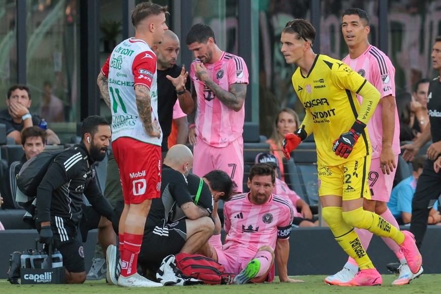 Aug 2, 2025; Fort Lauderdale, FL, USA; Inter Miami CF forward Lionel Messi (10) is looked at by trainees after a possible injury against Necaxa during the first half of a Leagues Cup group stage match at Chase Stadium. Mandatory Credit: Sam Navarro-Imagn Images