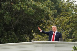 U.S. President Donald Trump gestures as he jokes to reporters that he's planning to install nuclear missiles, on a with an architect and aides on the roof of the White House in Washington, D.C., U.S., August 5, 2025. REUTERS/Jonathan Ernst