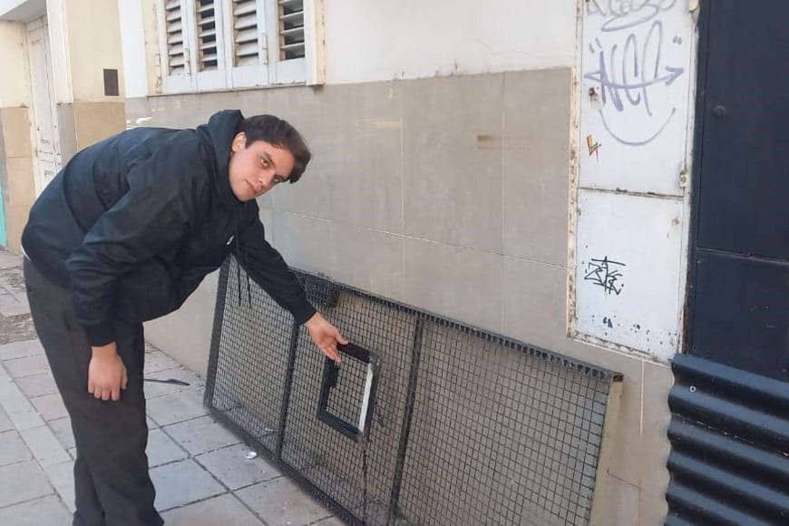 El empleado del comercio muestra la puerta dañada. Crédito: El Litoral.