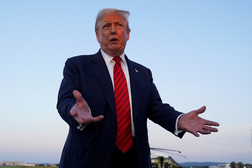 FILE PHOTO: U.S. President Donald Trump talks to members of the press at Lehigh Valley International Airport in Allentown, Pennsylvania, U.S., August 3, 2025. REUTERS/Ken Cedeno/File Photo