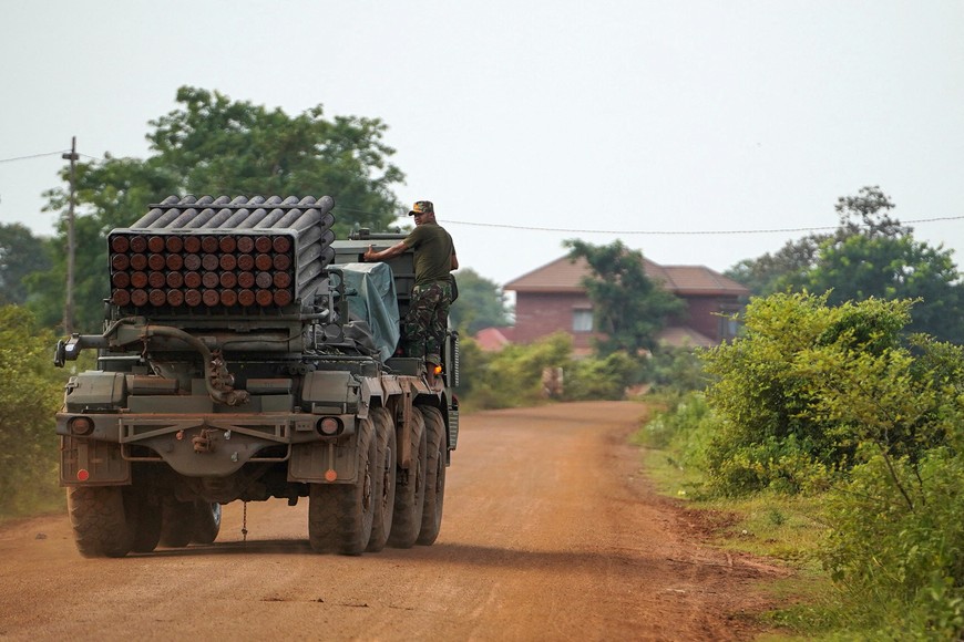 A Cambodian military personnel stands on a BM-21 Grad multiple rocket launcher, around 40 km (24 miles) from the disputed Ta Moan Thom temple, after Thailand and Cambodia exchanged heavy artillery on Friday as their worst fighting in more than a decade stretched for a second day, in Oddar Meanchey province, Cambodia, July 25, 2025. REUTERS/Soveit Yarn